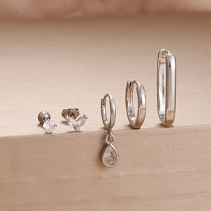 Detailed set of five silver stainless steel earrings with sparkling zircon stones