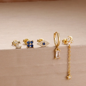 Detail of five-piece gold-plated earring set with zircon stars and bohemian tassels