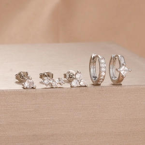 Macro shot of a 5-piece silver stainless steel earring set with clear zircon stones