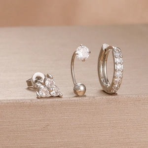 Detailed macro view of silver stainless steel earrings set featuring sparkling cubic zirconia