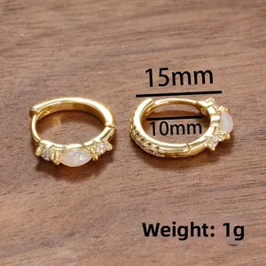 Close-up of 15mm gold-plated hoop earrings with marquise white opal and cubic zirconia
