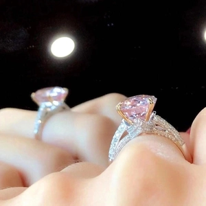 Elegant silver ring with a large oval pink gemstone and shimmering micro-pave accents