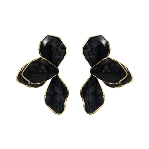 Macro detail of layered black enamel leaf earrings with elegant gold metallic edges