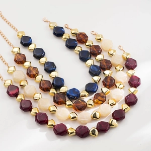 Detail of colorful hexagonal resin bead necklaces with gold spacers and lobster clasp