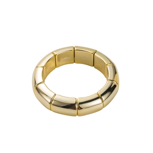 Close-up of golden elastic bracelet with polished rectangular metal tube segments