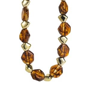 Detail view of large amber resin beads and polished gold geometric beads necklace