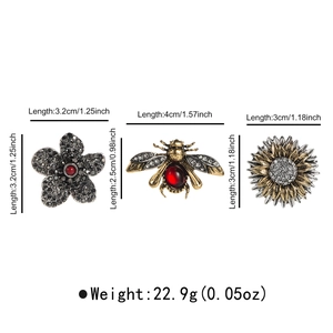 Detailed view of rhinestone flower, bee, and sunflower brooch set with size dimensions