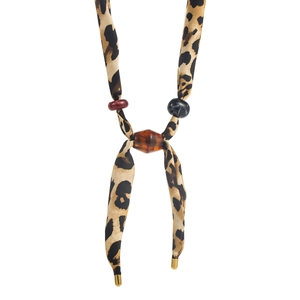 Detail of leopard print silk scarf necklace featuring amber resin beads and gold metal tips