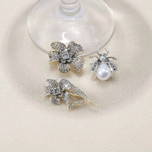 Detailed view of rhinestone flower and honeybee brooch set with elegant pearl accents