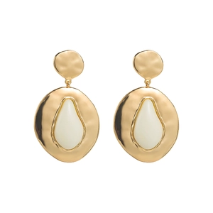 Detail of gold geometric drop earrings featuring hammered texture and white teardrop inlay