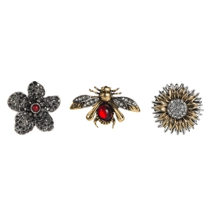 Detail view of rhinestone flower and honey bee brooch set with vintage gold finish