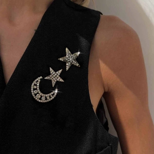 Luxury rhinestone crescent moon and star brooch set on dark suit jacket lapel