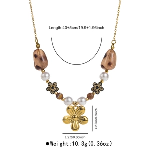 Detailed view of beaded necklace with 40+5cm length and golden flower pendant