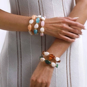 Pulsera bohemia con cuentas de resina de colores y espaciadores dorados en la muñeca