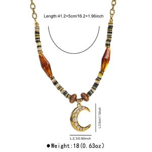 Detail view of vintage beaded necklace with moon pendant and dimension measurements