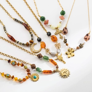 Detailed view of bohemian gold necklaces featuring turquoise beads and moon pendants