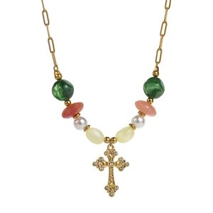Detail of vintage gold cross pendant with crystals on a colorful beaded chain necklace