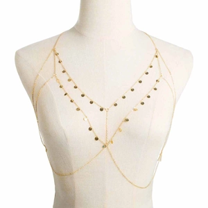 Layered gold body chain with shimmering sequins on a white mannequin for a stylish look