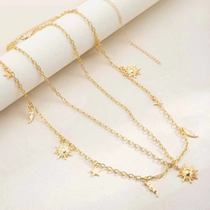 Detail of multi-layered gold celestial body chain with moon star and sun charms