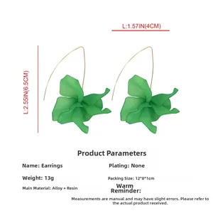 Detail view of long green resin flower earrings with gold hooks and size measurements