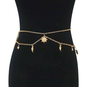 Bohemian gold waist chain with sun moon and star charms on a black display stand