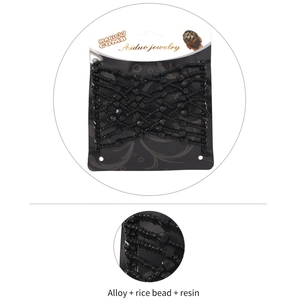 Detail of magic hair comb with black beads and elastic alloy cross weave structure
