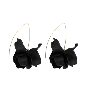 Detail of matte black multi-layered floral earrings with slim gold long wire hooks