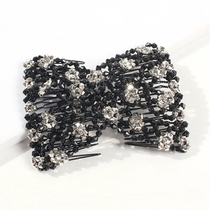 Detail of magic hair comb with black and silver faceted beads in a bow design