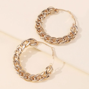 Detailed close-up of large gold chunky Cuban link chain hoop earrings for women