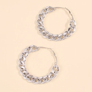Detailed close-up of large chunky silver chain hoop earrings with a polished finish