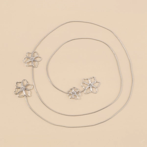 Detailed view of silver snake chain necklace featuring elegant hollow flower accents