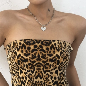 Close-up of a punk style chunky silver chain necklace with a sparkling heart pendant
