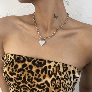 Punk style silver chunky chain necklace with a shimmering diamond heart pendant