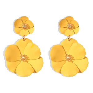 Detail of yellow double-layered floral earrings with matte finish and golden bead center