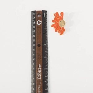 Detailed top view of 4.5cm orange floral earring with gold edges and measurement scale