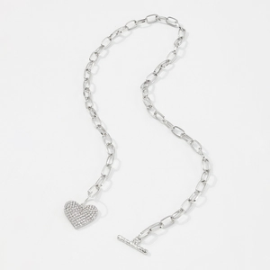 Detail of silver link chain necklace with a heart pendant and toggle clasp closure