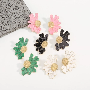 Detail of vintage enamel flower earrings in pink black green and white colors