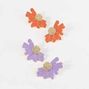Detail of vintage flower stud earrings with golden honeycomb centers in orange and purple