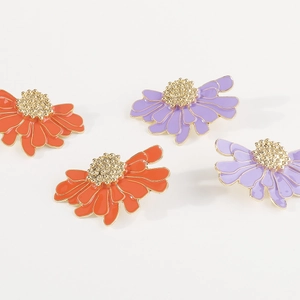 Macro detail of vintage floral earrings with purple and orange enamel and gold edges