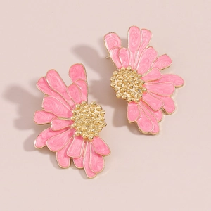 Macro shot of pink floral stud earrings with golden texture and daisy petal details