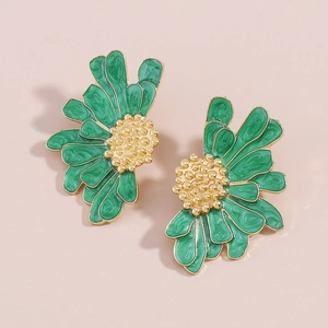 Detailed macro view of vintage emerald green daisy stud earrings with golden texture
