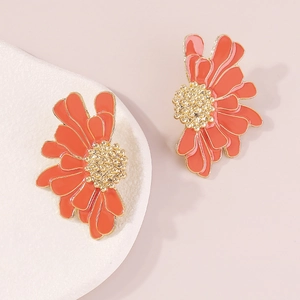 Detail of orange enamel flower earrings with gold-tone metal petals and beaded center
