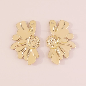Detail view of gold flower earrings with petal texture and embossed A and B markers