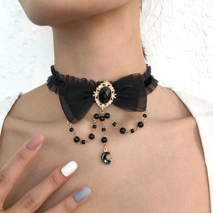 Gothic lace choker featuring a black bow, crescent moon pendant, and faux pearls