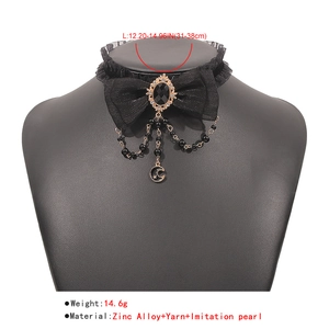 Detail of gothic black lace choker with bow, star moon pendant and pearl beads