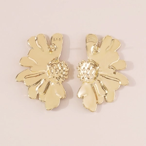 Detailed macro view of vintage golden floral earrings featuring textured petals and A-B marks