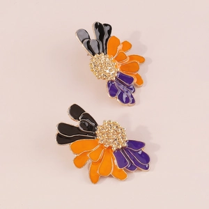 Macro shot of colorful floral earrings with enamel petals and gold textured centers