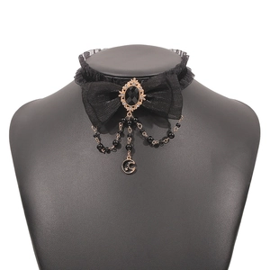 Detail view of gothic lace choker with black bow, beads and golden crescent moon pendant