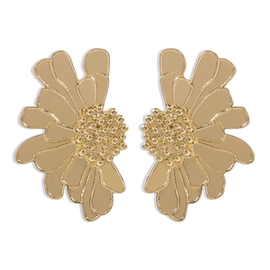 Detailed view of vintage-style golden flower earrings with textured metallic petals