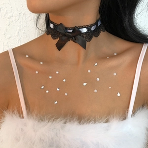 Detail of black lace choker necklace with a satin bow knot on a female model